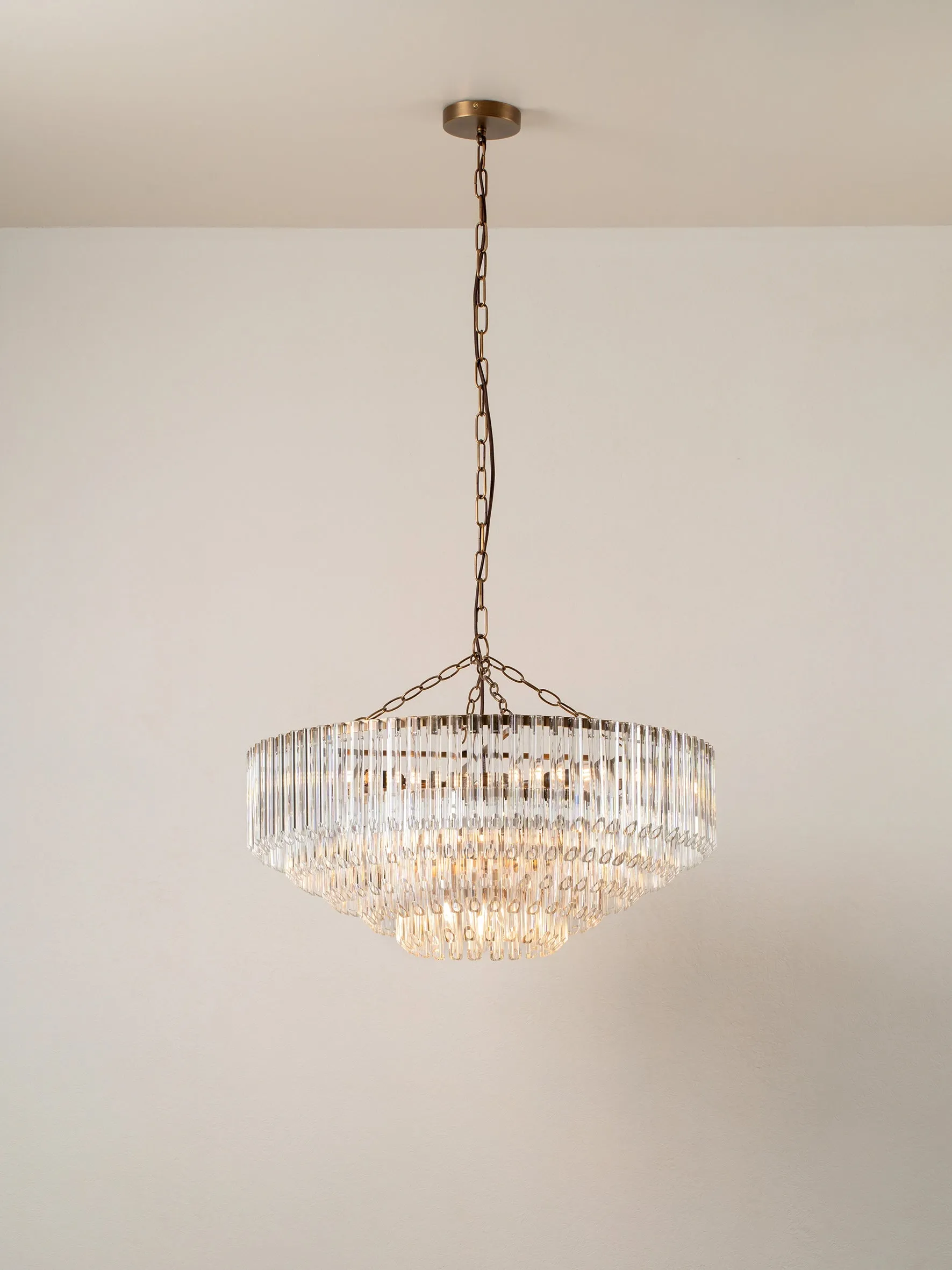 Petalia - 9 light aged brass and clear glass tube wide chandelier